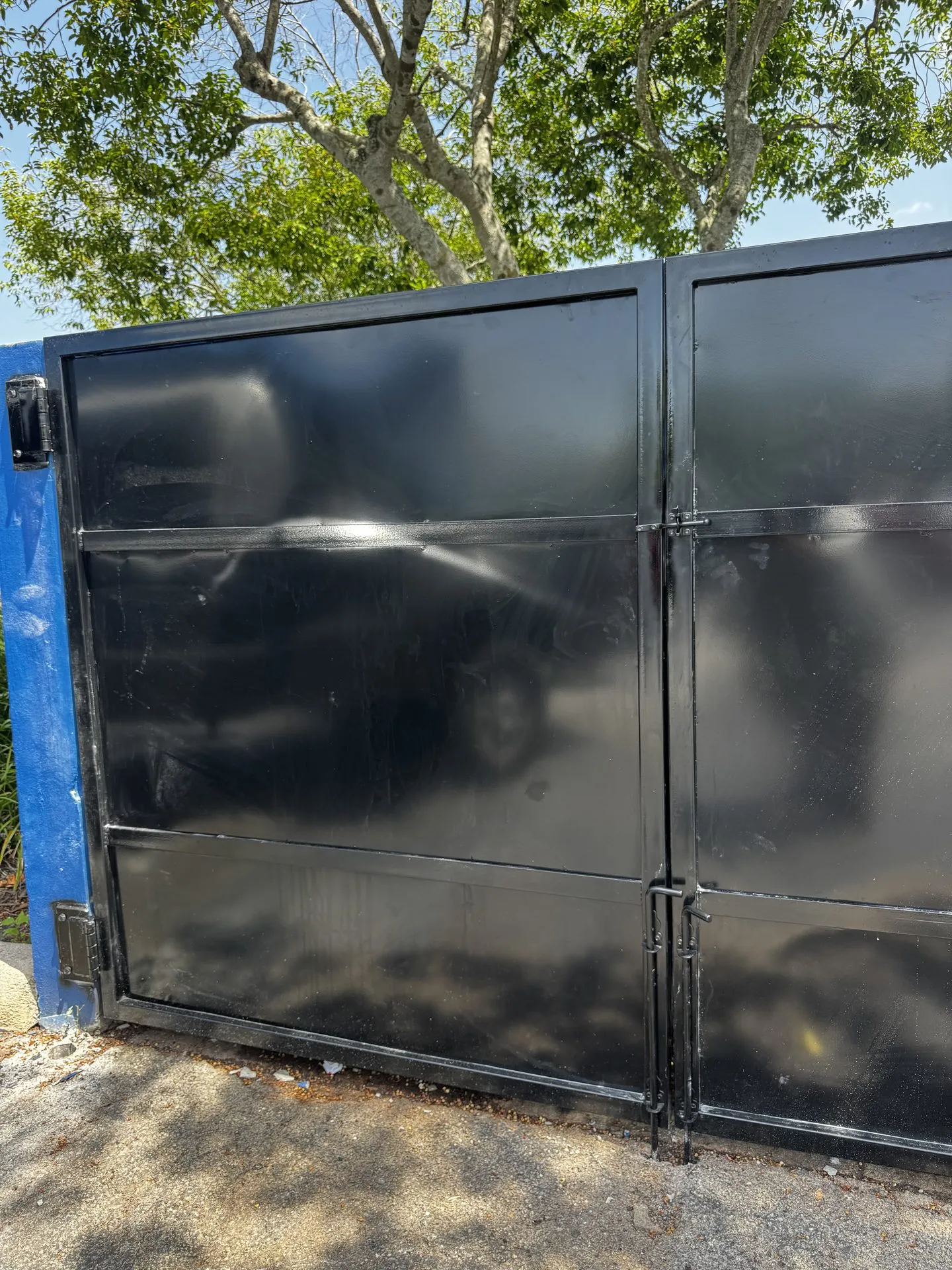 Close-up of a custom fabricated steel dumpster enclosure gate