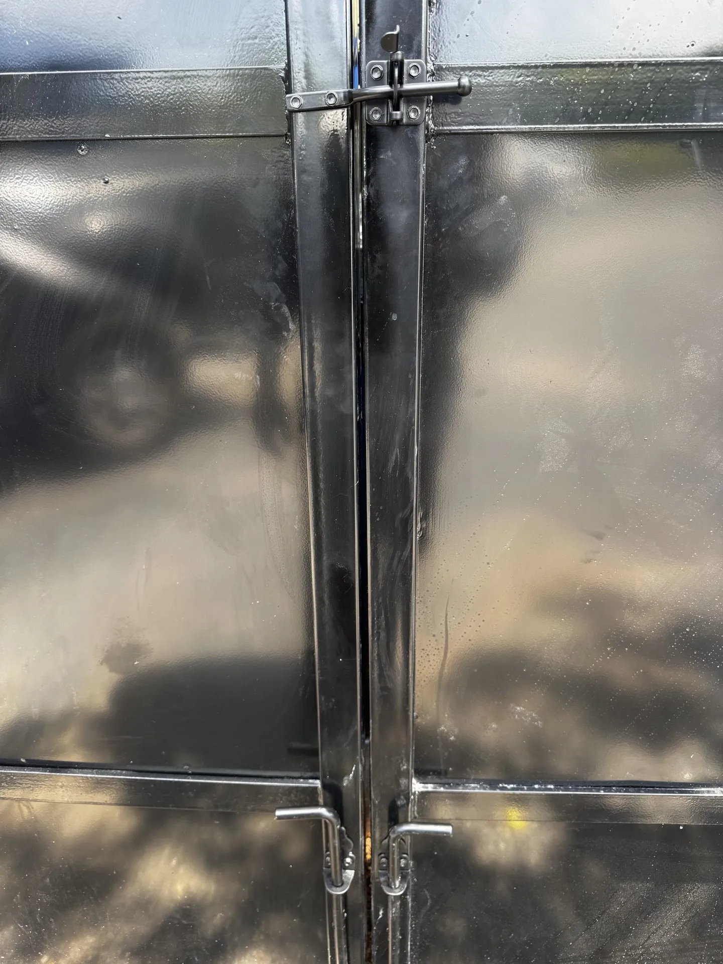 Steel dumpster enclosure gate with locking hardware