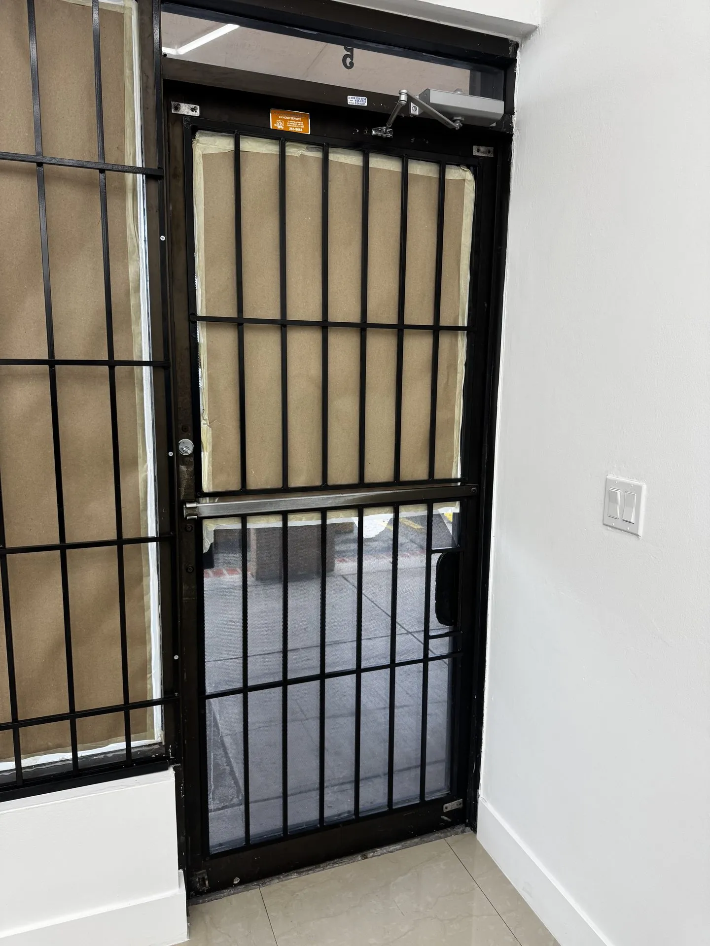 Security storm door with a custom iron bar grille