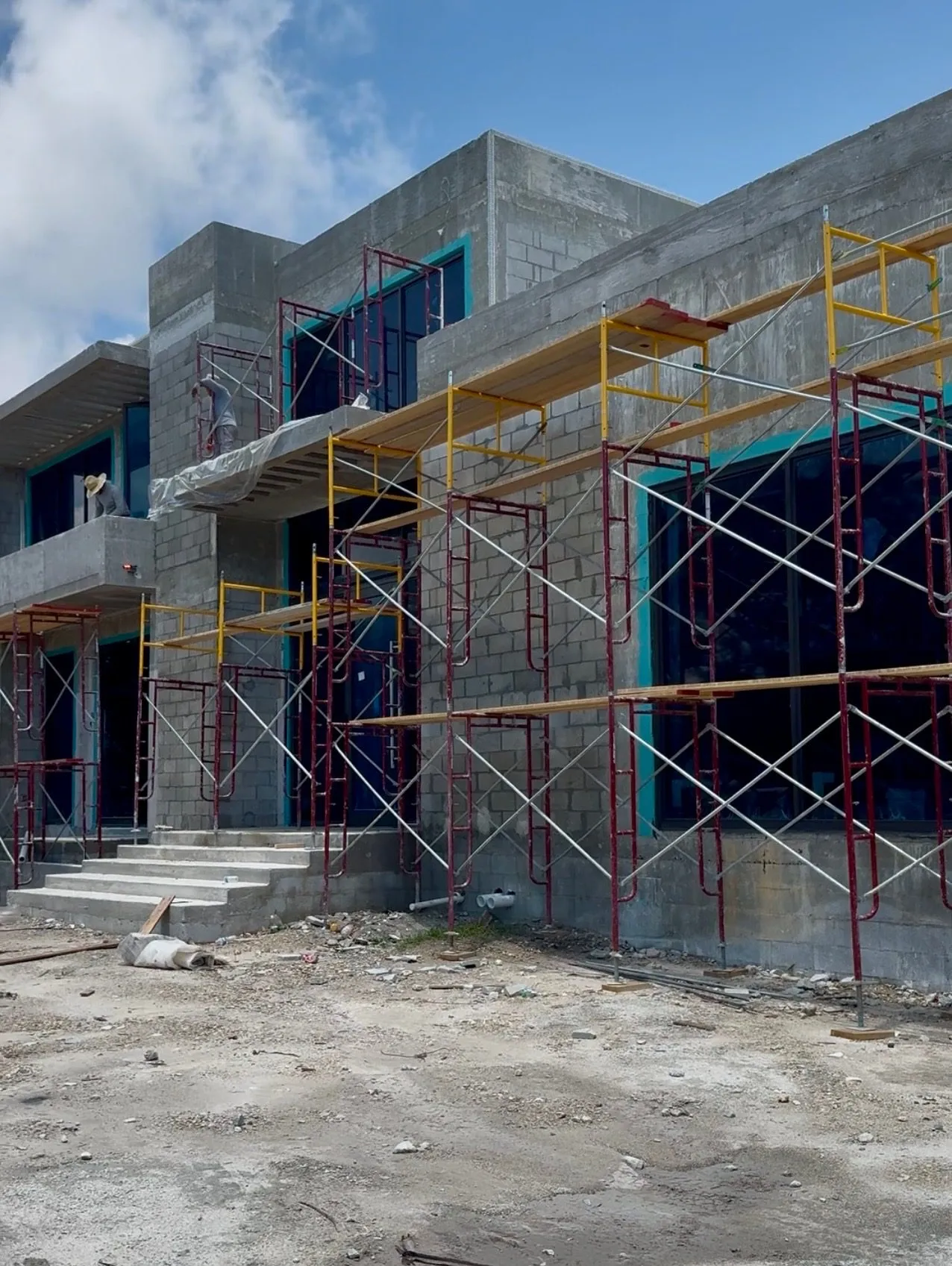 Multi-story concrete block building with scaffolding in Miami-Dade County