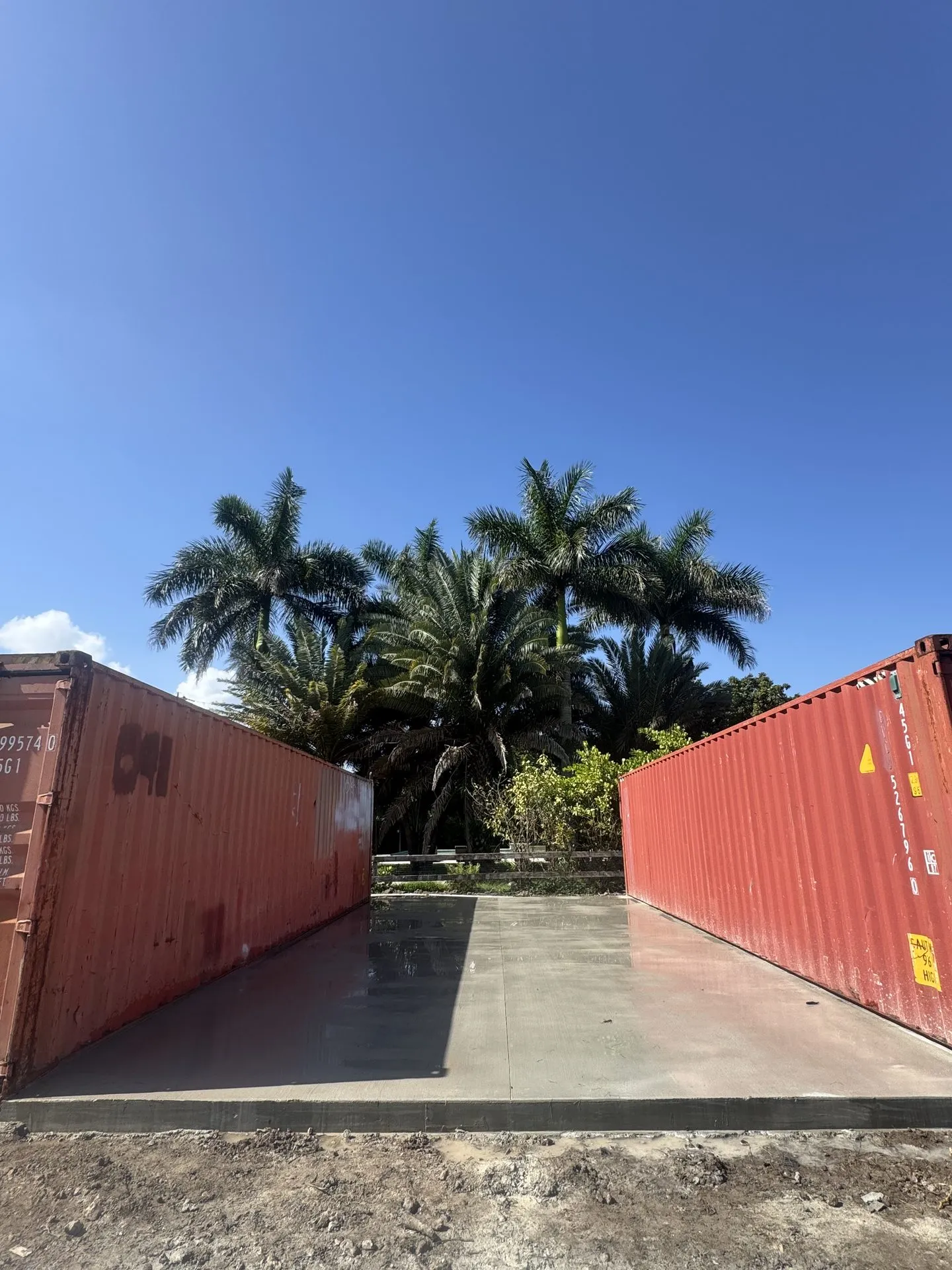 Newly poured concrete slab between two shipping containers