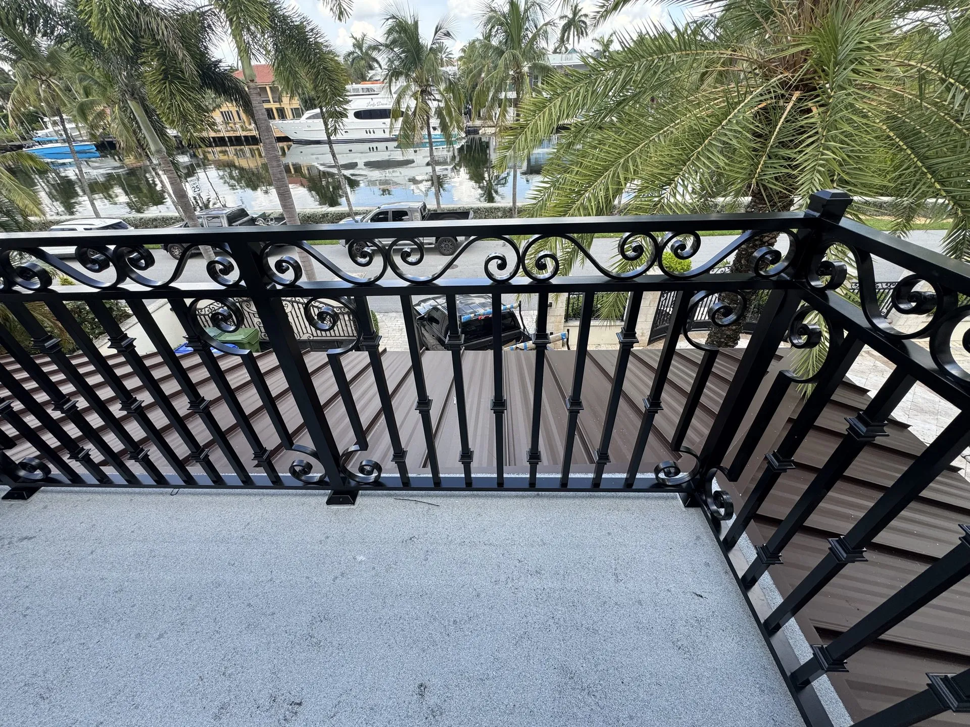 Custom wrought iron balcony railing overlooking a marina in Miami