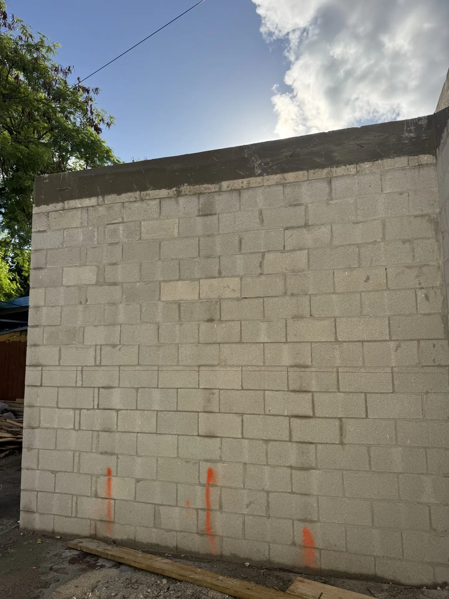 Freshly laid concrete block wall marked for the next phase of work
